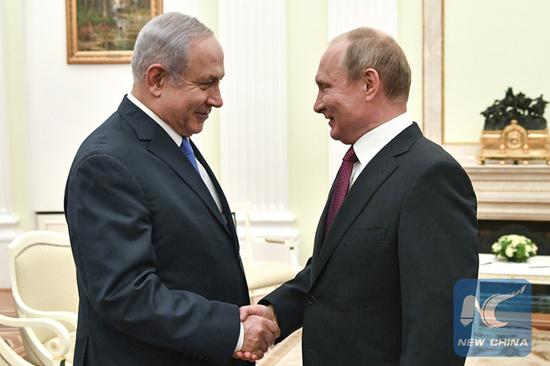 Russian President Vladimir Putin, right, shakes hands with Israeli Prime Minister Benjamin Netanyahu during their meeting at the Kremlin in Moscow, Wednesday, July 11, 2018. (Pool photo via AP)