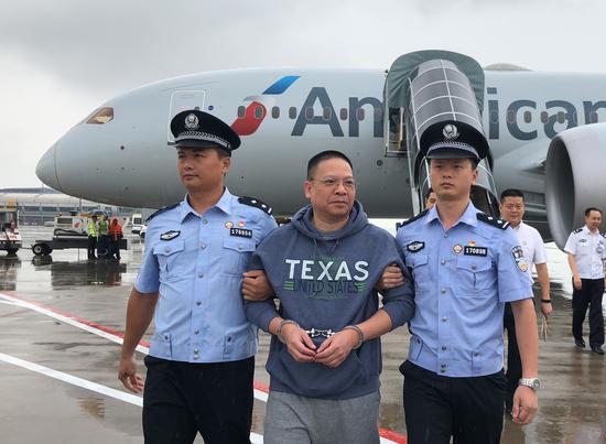 Xu Chaofan, former head of a Bank of China subbranch who fled to the U.S., arrives in Beijing on Wednesday. (Photo/Xinhua)