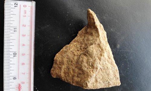 One of the stone tools excavated in Shangchen historical site in Northwest China's Shaanxi Province. It was chipped to this form by human ancestors 2.1 million years ago. (Photo/courtesy of Zhu Zhaoyu)
