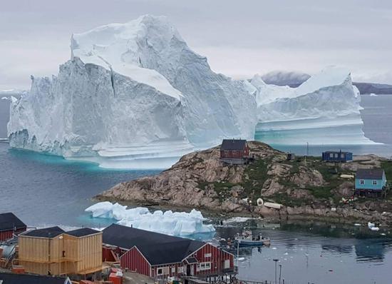 Massive iceberg threatens Greenland village