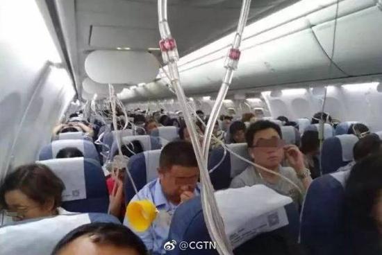 Passengers put on their oxygen masks after an Air China plane plunged 23,000 feet mid-air on July 10, 2018. (Photo/CGTN Weibo)