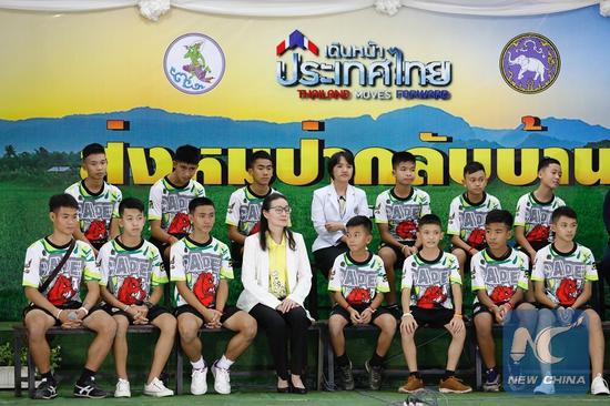 The 12 boys and their football coach rescued from a flooded cave in northern Thailand made their first public appearance here at a press conference on Wednesday. (Xinhua/Rachen)