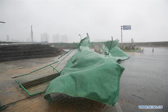 Fences are blown down by wind at Wusongkou International Cruise Terminal in Shanghai, east China, July 22, 2018.  (Xinhua/Ding Ting)