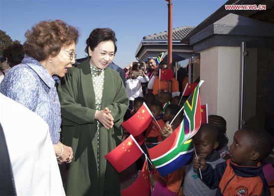 Peng Liyuan, wife of Chinese President Xi Jinping and a UNESCO Special Envoy for the Advancement of Girls' and Women's Education, visits Uthando Day Care Pre-school in the east suburb of Pretoria, South Africa, July 24, 2018. Peng was accompanied by Tshepo Motsepe, wife of South African President Cyril Ramaphosa during the visit. (Xinhua/Wang Ye)