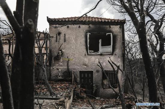 A burned house is seen in Mati, a seaside town east of Athens, Greece, on July 24, 2018.  (Xinhua/Lefteris Partsalis)