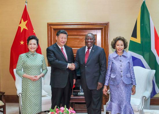President Xi Jinping meets with his South African counterpart, Cyril Ramaphosa, in Pretoria, South Africa, on Tuesday. They are accompanied by Xi’s wife, Peng Liyuan, and Ramaphosa’s wife, Tshepo Motsepe. (XIE HUANCHI/XINHUA)
