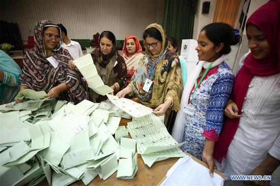 Election officials count votes in Islamabad, capital of Pakistan, on July 25, 2018. Pakistanis started casting votes in the country's one-day general elections commenced on Wednesday morning, which would elect the members of the National Assembly, the lower house of the country's parliament, and of the four provincial assemblies. (Xinhua/Ahmad Kamal)