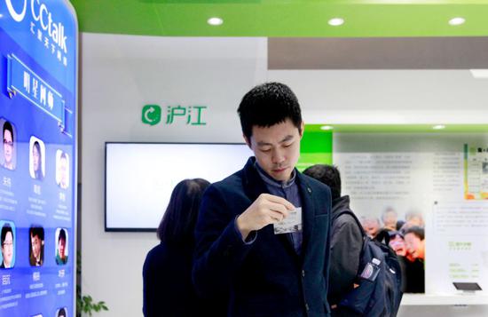 A visitor reads a pamphlet at the booth of Hujiang EdTech at a high-tech exhibition in Wuzhen, Zhejiang province. (Photo provided to China Daily)
