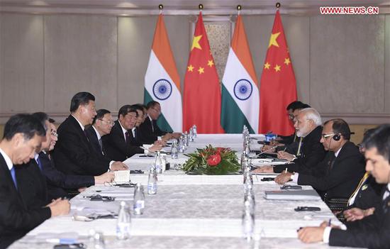 Chinese President Xi Jinping meets with Indian Prime Minister Narendra Modi in Johannesburg, South Africa, July 26, 2018. (Xinhua/Yan Yan)
