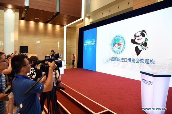 Journalists work at an unveiling ceremony of the mascot and logo of the China International Import Expo (CIIE) in Shanghai, east China, July 27, 2018. China unveiled the mascot and the logo for the expo on Friday. (Xinhua/Jin Liangkuai)