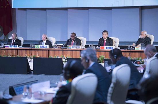 Chinese President Xi Jinping makes a speech to an outreach dialogue grouping leaders from the BRICS, the 