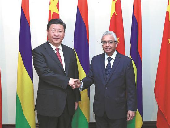 President Xi Jinping meets Mauritian Prime Minister Pravind Jugnauth in Mauritius on Saturday. Earlier, Xi paid state visits to the United Arab Emirates, Senegal, Rwanda and South Africa, and attended the 10th BRICS Summit in Johannesburg. (PANG XINGLEI/XINHUA)