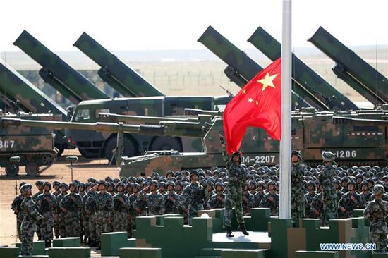 The flag raising ceremony during the military parade at Zhurihe training base in North China's Inner Mongolia autonomous region Sunday, July 30, 2017. (Photo/Xinhua)