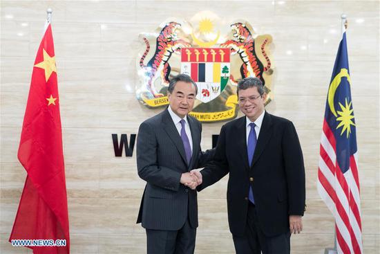 Chinese State Councilor and Foreign Minister Wang Yi (L) shakes hands with Malaysian Foreign Minister Saifuddin Abdullah prior to their talks in Malaysia, July 31, 2018. China is willing to maintain friendly policies towards Malaysia to deepen cooperation and benefit people of both countries, said Wang Yi here on Tuesday when meeting with Malaysian Foreign Minister Saifuddin Abdullah. (Xinhua/Zhu Wei)
