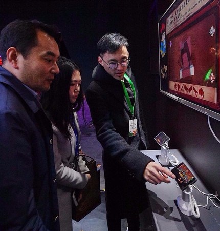 Visitors try out games developed by contestants taking part in Next Idea, a technology and culture competition held by Tencent, in the Palace Museum in Beijing. (Provided to China Daily)