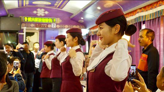 Cabin crew on one of the tourism trains along Tangzhu Road. (Photo provided to China Daily)