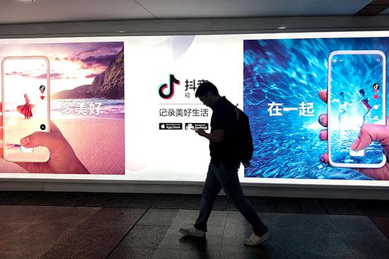 A man passes an advertisement for Douyin in Shanghai. Chinese short video apps such as Douyin have received a boost in recent months, with a particular focus on overseas markets. (Photo provided to China Daily)