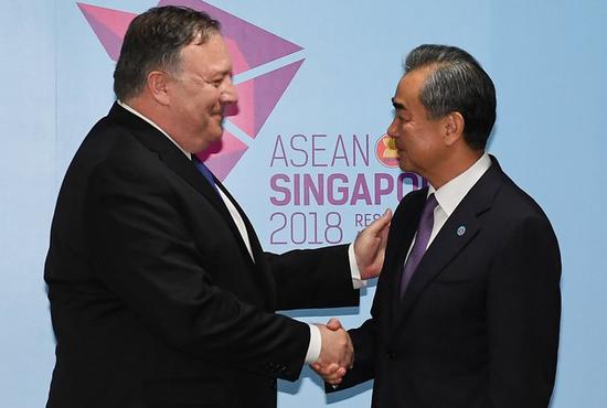 U.S. Secretary of State Mike Pompeo and China's Foreign Minister Wang Yi shake hands before their bilateral meeting at the 51st Association of Southeast Asian Nations (ASEAN) in Singapore, August 3, 2018. (Photo/Agency)