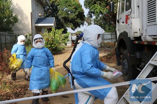 File photos show Chinese mobile laboratory team get into a laboratory in Freetown, capital of Sierra Leone, Jan. 23, 2015 amid an Ebola outbreak. (Xinhua/Zhang Ke)