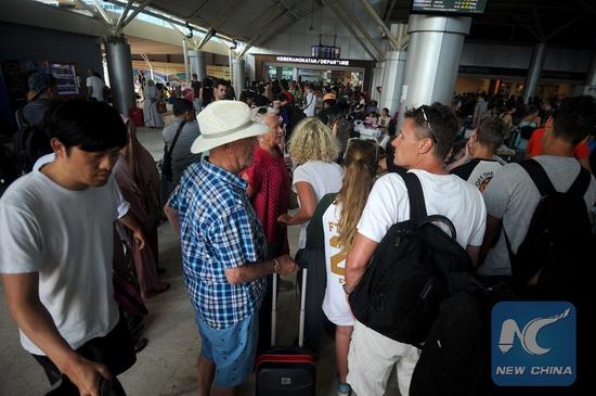 Tourists wait to check in at Praya International airport on Lombok Island, Indonesia, Aug. 6, 2018. (Xinhua/Agung Kuncahya B.)