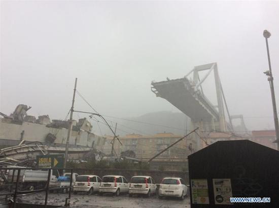 Photo taken on Aug. 14, 2018 shows a partially collapsed bridge in Genoa, Italy. At least 22 people died in the collapse of a major motorway bridge in the northwest Italian city of Genoa on Tuesday. (Xinhua)