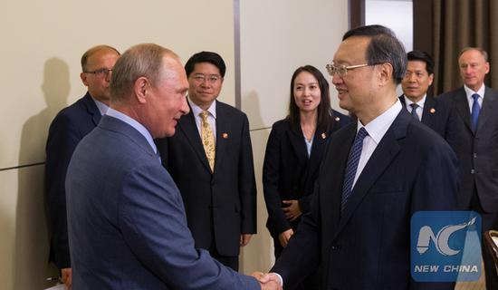 Russian President Vladimir Putin shakes hands with Yang Jiechi, a member of the Political Bureau of the Communist Party of China (CPC) Central Committee, in Sochi, Russia, on August 15, 2018. (Xinhua/Bai Xueqi)