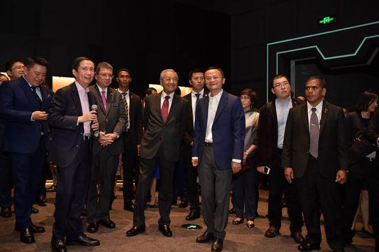 Malaysian Prime Minister Mahathir Mohamad tours Alibaba's exhibition area with Alibaba's founder Jack Ma in Hangzhou city, Zhejiang Province, August 18, 2018. /CGTN Photo