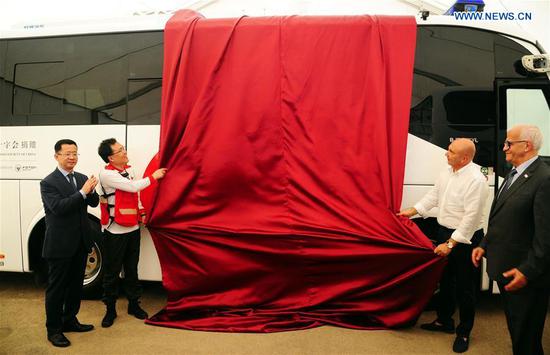 Officials from the Red Cross Society of China (RCSC) and Syria's Arab Red Crescent (SARC) inaugurate a mobile medical clinic at the donation ceremony in Damascus, Syria, on Aug. 16, 2018. (Photo/Xinhua)