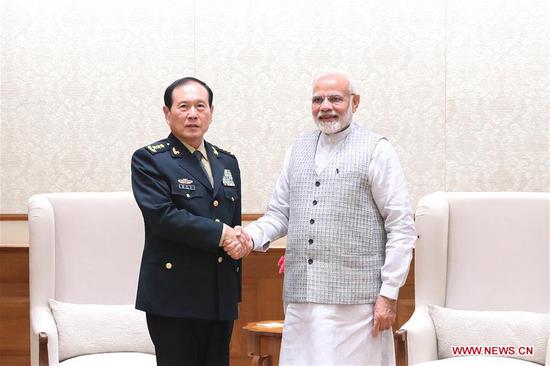 Indian Prime Minister Narendra Modi (R) shakes hands with visiting Chinese State Councilor and Defense Minister Wei Fenghe on Aug. 21, 2018, in New Delhi, India. China and India pledged on Tuesday to further strengthen ties between the two countries and their militaries. (Xinhua)