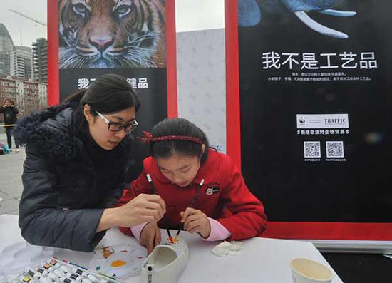 A child attends an Earth Hour activity in Shanghai in March 2016. The event was started in 2007 by the WorldWide Fund for Nature, an environmental NGO. (Photo/China Daily)