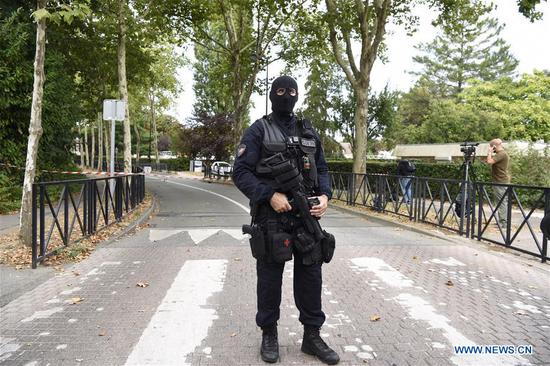 A riot policeman stands on guard at the scene of an attack, in Paris suburbs, France, on Aug. 23, 2018. A man in his 30s stabbed two persons to death and wounded one more before being shot dead by police in Trappes, west of Paris, according to local media. (Xinhua/Chen Yichen)