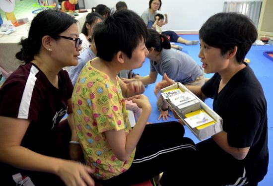 Sze Ka-yan, who has the intellectual capacity of a 2-year-old, receives regular cognitive therapy. China Daily