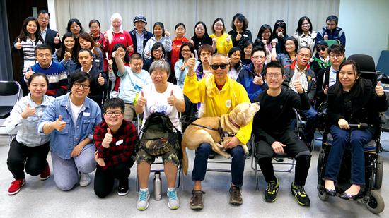 Pompe patient Terry Lai (first row, second right) works in the Hong Kong Alliance of Rare Diseases' campaigns to seek welfare rights for rare-disease patients in the city. (Photo/China Daily)