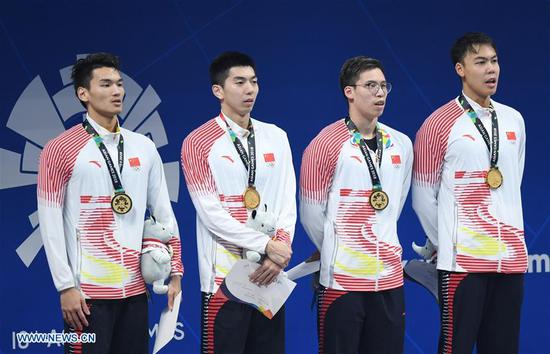 Xu Jiayu, Yan Zibei, Li Zhuhao and Yu Hexin (from L to R) attend the awarding ceremony of men's 4x100m medley relay final of swimming at the 18th Asian Games in Jakarta, Indonesia, Aug. 24, 2018. China won the gold medal. (Xinhua/Yue Yuewei)