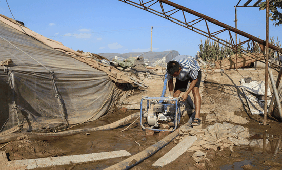 A farmer fuels a pump to drain water from his greenhouse in Shouguang, Shandong Province, on Sunday.  (ZHANG YANAN/FOR CHINA DAILY)