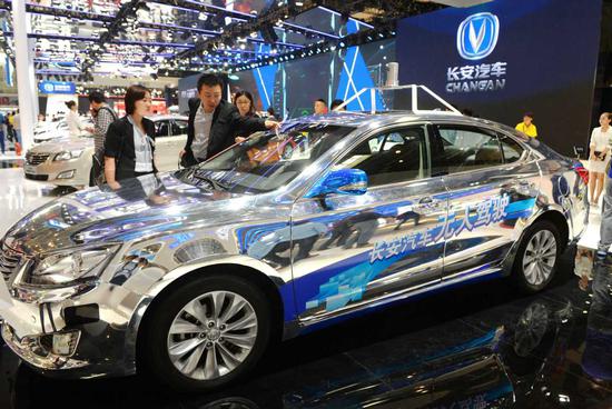 An autonomous car designed by Chongqing Changan Automobile Co catches attention at an auto show in Beijing. (Photo by Hu Qingming/For China Daily)