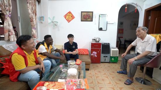 Michel and other Chinese social workers visiting a local senior.  /CGTN Photo