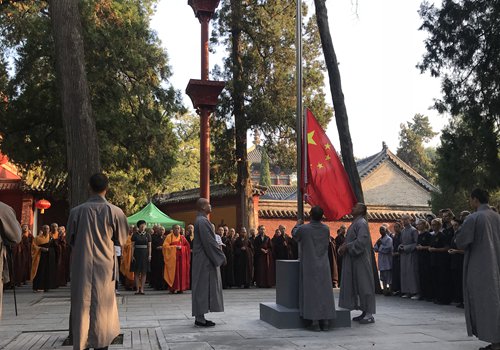 Monks at the Shaolin Temple in Central China's Henan Province, as well as local religious authorities, attend the flag-raising ceremony on Monday. (Photo/Courtesy of the Shaolin Temple)