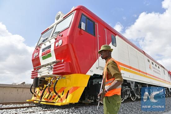 A man stands guard during the reception ceremony of the first batch of locomotives for the Mombasa-Nairobi standard gauge railway in Mombasa, Kenya, January 11, 2017. /Xinhua Photo