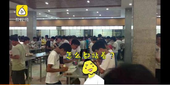 Screenshot of footage shows students standing beside tables in Suixian High School on August 26.