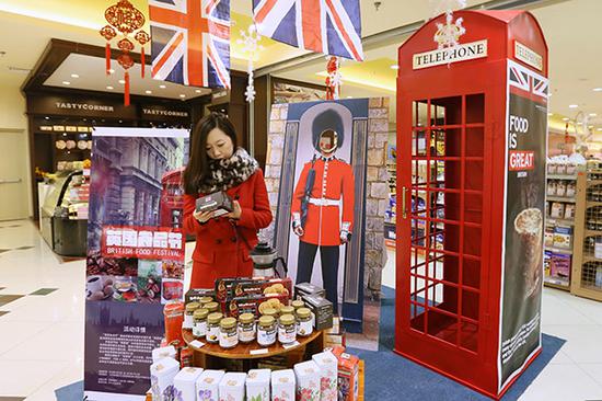 A woman examines food imported from the United Kingdom at a supermarket in Beijing. (Photo/China Daily)