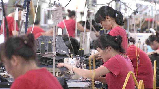 Factory workers at Hodo's assembly lines in Wuxi, Jiangsu Province. /CGTN Photo