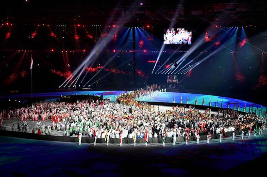 Athletes enter the Gelora Bung Karno (GBK) Main Stadium during the closing ceremony of the 18th Asian Games in Jakarta, Indonesia, Sept. 2, 2018.(Xinhua/Pan Yulong)