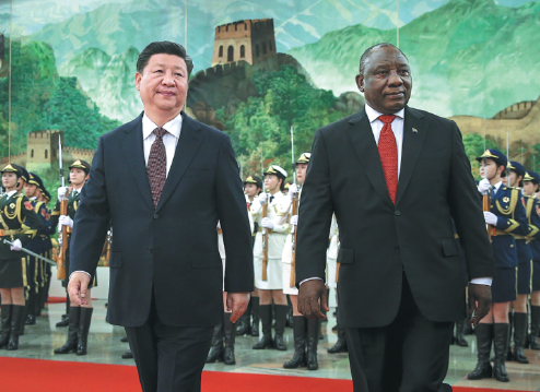 President Xi Jinping accompanies South African President Cyril Ramaphosa in the Great Hall of the People in Beijing on Sunday. (FENG YONGBIN/CHINA DAILY)