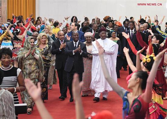 Foreign leaders and their spouses attending the Beijing Summit of the Forum on China-Africa Cooperation (FOCAC) are greeted by young performers on their way to a welcoming banquet held by Chinese President Xi Jinping and his wife Peng Liyuan at the Great Hall of the People in Beijing, capital of China, Sept. 3, 2018. (Xinhua/Shen Hong)