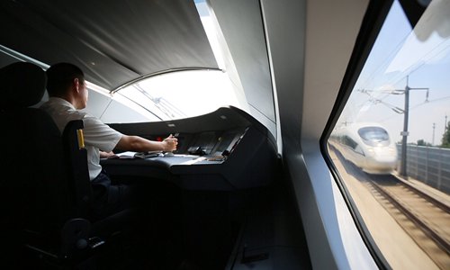 Xue Jun drives a bullet train. (File photo/Courtesy of China Railway Corp)