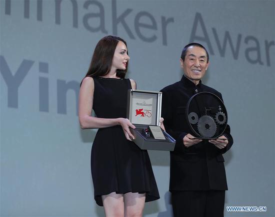 Chinese Director Zhang Yimou (R) receives the Jaeger-LeCoultre Glory to the Filmmaker prize during the 75th Venice International Film Festival in Venice, Italy, Sept. 6, 2018. (Xinhua/Cheng Tingting)