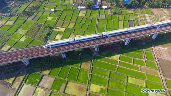 A bullet train runs in Qionghai City, South China's Hainan province, Jan 18, 2018. (Photo/Xinhua)