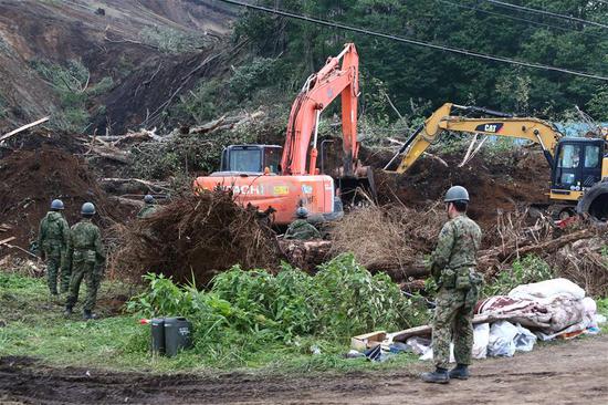 Rescue members operate excavators at a site of landslide due to earthquake in the town of Atsuma, Hokkaido prefecture, Japan, on Sept. 7, 2018. A total of 21 people have been confirmed dead, six others in state of cardiopulmonary arrest, and 13 people remain missing in the wake of a powerful earthquake that rocked Hokkaido Prefecture in northern Japan on Thursday, Japanese government said on Saturday. (Xinhua/Ma Caoran) 