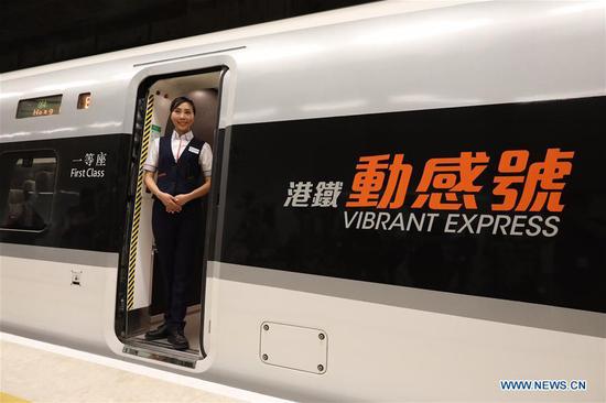 An attendant is seen on a train of the Guangzhou-Shenzhen-Hong Kong Express Rail Link (XRL), in Hong Kong, south China, Aug. 16, 2018.  (Xinhua/Lui Siu Wai)